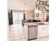 Modern kitchen with stainless steel dishwasher, granite countertops, and access to a patio at 5005 Mill Stream Rd, Ocoee, FL 34761