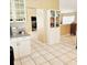 Bright kitchen featuring white cabinets and shelving with granite countertops at 5005 Mill Stream Rd, Ocoee, FL 34761