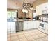 Modern kitchen with white cabinets, stainless steel appliances, and a view to the backyard at 5005 Mill Stream Rd, Ocoee, FL 34761