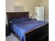 Bedroom with a dark wood bed and nightstands, and a door leading to another room at 5005 Mill Stream Rd, Ocoee, FL 34761