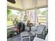 Cozy screened porch with comfortable seating, striped cushions, decorative curtains, and peaceful views of the backyard at 5005 Mill Stream Rd, Ocoee, FL 34761
