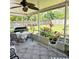 Charming screened porch with patio furniture, ceiling fan, plants, and views of the backyard at 5005 Mill Stream Rd, Ocoee, FL 34761