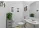 Cozy half bathroom with a pedestal sink, decorative mirror, and neutral decor at 588 Hitch Loop, St Cloud, FL 34769