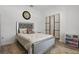 Bright bedroom with a silver-framed bed, decorative pillows, a stylish rug, and a sliding door closet at 588 Hitch Loop, St Cloud, FL 34769