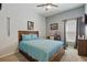 Bedroom featuring a wooden bed frame, ceiling fan, wall art, and carpet at 588 Hitch Loop, St Cloud, FL 34769