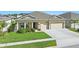 Charming single-Gathering home with well-manicured lawn, a two-car garage, and inviting curb appeal at 588 Hitch Loop, St Cloud, FL 34769