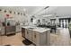 Spacious kitchen features stainless steel appliances, large island, and modern cabinetry at 588 Hitch Loop, St Cloud, FL 34769