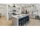 Modern kitchen with a large island, breakfast bar, and stainless steel appliances at 588 Hitch Loop, St Cloud, FL 34769