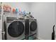 Convenient laundry room with Samsung washer and dryer, storage shelves, and organized supplies at 588 Hitch Loop, St Cloud, FL 34769