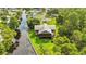 Aerial view of a two-story waterfront home near a canal at 6375 Topsy Trl, St Cloud, FL 34771