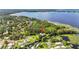 Aerial view of a waterfront home in a lush, green neighborhood by the lake at 6375 Topsy Trl, St Cloud, FL 34771