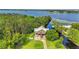Stunning aerial view of waterfront home with lush trees and expansive waterway views at 6375 Topsy Trl, St Cloud, FL 34771