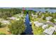 An aerial view of a waterfront community with a canal leading to the lake and homes with docks at 6375 Topsy Trl, St Cloud, FL 34771