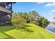 Sprawling backyard with lush grass, a waterfront view, and mature trees at 6375 Topsy Trl, St Cloud, FL 34771