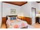 Cozy bedroom with wooden wainscoting, warm colors, and decorative pillows at 6375 Topsy Trl, St Cloud, FL 34771