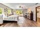 Bright bedroom with hardwood floors and access to a private balcony and an ensuite bathroom at 6375 Topsy Trl, St Cloud, FL 34771