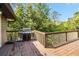 A wood deck area with a grill overlooking greenery at 6375 Topsy Trl, St Cloud, FL 34771