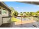 Waterfront home features an outdoor wood deck with railings overlooking a wooded canal at 6375 Topsy Trl, St Cloud, FL 34771