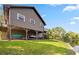 Waterfront home featuring boat storage, watercraft lift, and beautiful landscaping at 6375 Topsy Trl, St Cloud, FL 34771