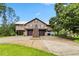Two-story waterfront home with a large driveway and garages underneath at 6375 Topsy Trl, St Cloud, FL 34771