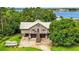 Two-story waterfront home with a large driveway and garages underneath at 6375 Topsy Trl, St Cloud, FL 34771