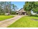 Exterior elevation features a long driveway, raised front deck, and a boat on a trailer at 6375 Topsy Trl, St Cloud, FL 34771