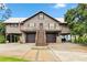 Inviting elevated home featuring covered parking, charming balconies, and a grand staircase at 6375 Topsy Trl, St Cloud, FL 34771