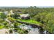 A stunning exterior view of the home nestled along a canal, surrounded by lush greenery and palm trees at 6375 Topsy Trl, St Cloud, FL 34771