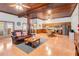 Open-concept living area with wood-paneled ceilings, living and dining areas, plus kitchen at 6375 Topsy Trl, St Cloud, FL 34771
