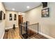 Upper hallway features views of artwork and a spiral staircase at 6375 Topsy Trl, St Cloud, FL 34771