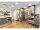 Modern kitchen featuring stainless steel appliances, gray cabinets, and wood flooring at 6375 Topsy Trl, St Cloud, FL 34771