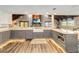 Modern kitchen featuring stainless appliances, large island, farmhouse sink, and wood beam details at 6375 Topsy Trl, St Cloud, FL 34771