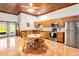 Kitchen dining area features stainless steel appliances, tile floors, and wood cabinets at 6375 Topsy Trl, St Cloud, FL 34771