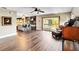 Spacious living room featuring an open floor plan, hardwood floors, and sliding glass doors to outdoor deck at 6375 Topsy Trl, St Cloud, FL 34771