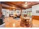 Expansive living room with wood plank ceiling, tile floors, and bedroom seating area at 6375 Topsy Trl, St Cloud, FL 34771