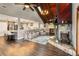 Open-concept living area with stone fireplace, wood vaulted ceilings, and natural light at 6375 Topsy Trl, St Cloud, FL 34771