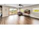 Open living room boasts hardwood floors, waterfront views, and access to a private balcony at 6375 Topsy Trl, St Cloud, FL 34771