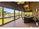 Outdoor screened porch area features comfortable seating and serene views of the waterfront at 6375 Topsy Trl, St Cloud, FL 34771