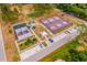 Aerial view of community amenities including tennis courts, playground, and parking area surrounded by trees at 712 Maryland Ave, St Cloud, FL 34769