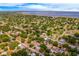 Aerial view of a quiet neighborhood near the water, with lush greenery and clear blue skies above at 712 Maryland Ave, St Cloud, FL 34769