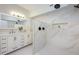 Bright bathroom features double vanity and walk-in shower with marble tiling at 712 Maryland Ave, St Cloud, FL 34769