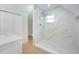 Modern bathroom with sleek shower, gold hardware, and white marbled tile at 712 Maryland Ave, St Cloud, FL 34769