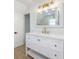 Bathroom features a double vanity and a large mirror at 712 Maryland Ave, St Cloud, FL 34769