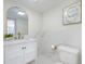 Bathroom with marble tiling, modern fixtures and gold accents at 712 Maryland Ave, St Cloud, FL 34769
