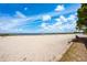 Wide sandy beach on a sunny day with scattered beachgoers and volleyball net visible at 712 Maryland Ave, St Cloud, FL 34769