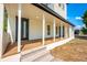 Inviting front porch with sturdy columns and a spacious seating area, ideal for relaxing and entertaining guests at 712 Maryland Ave, St Cloud, FL 34769