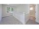 Hallway showcasing stairs, natural light, and access to an upstairs bathroom at 712 Maryland Ave, St Cloud, FL 34769