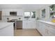 Well-lit kitchen with stainless steel appliances and modern white cabinetry at 712 Maryland Ave, St Cloud, FL 34769