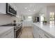 Modern kitchen with stainless steel appliances, white cabinets and ample countertop space at 712 Maryland Ave, St Cloud, FL 34769