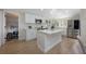 The kitchen features white cabinets, stainless steel appliances and a marble countertop island at 712 Maryland Ave, St Cloud, FL 34769
